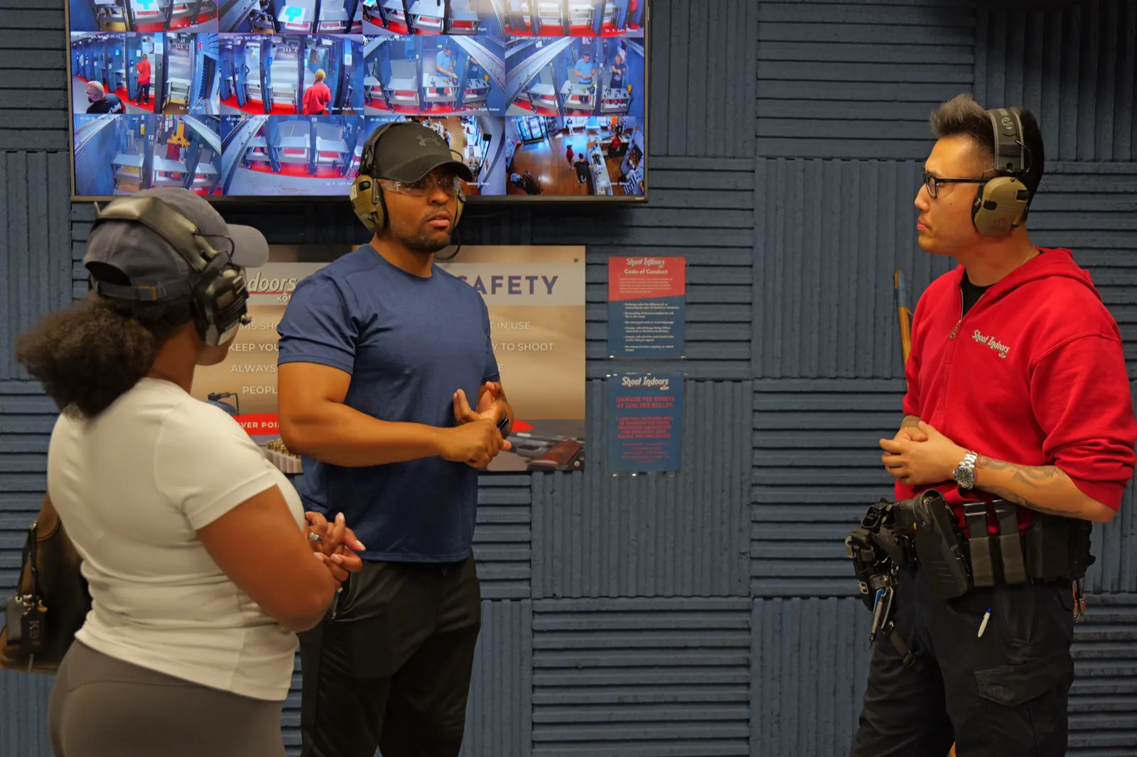 Range safety officer briefing guests beside live lane monitors